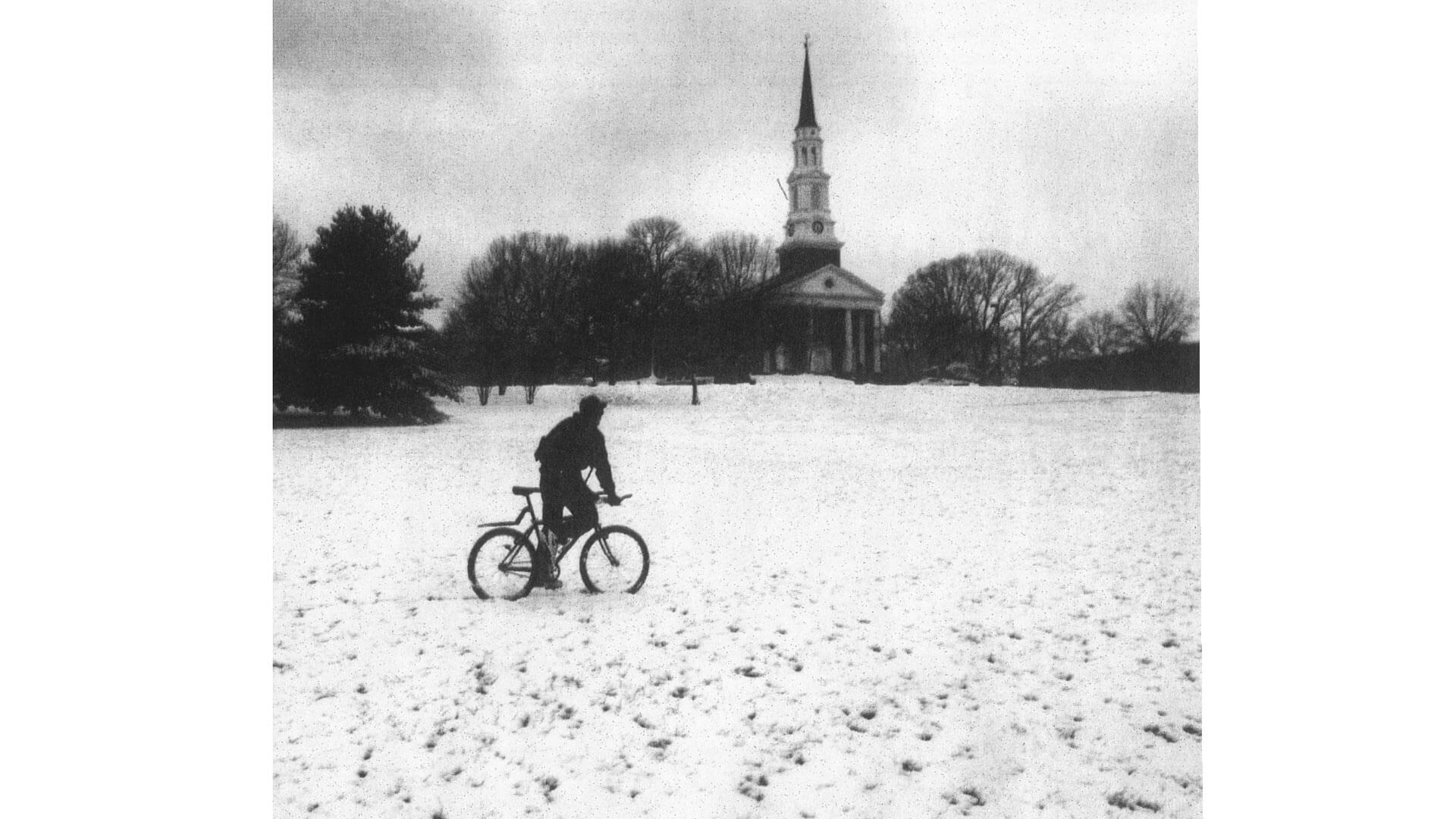 Student rides bike in the snow at UMD in 2005