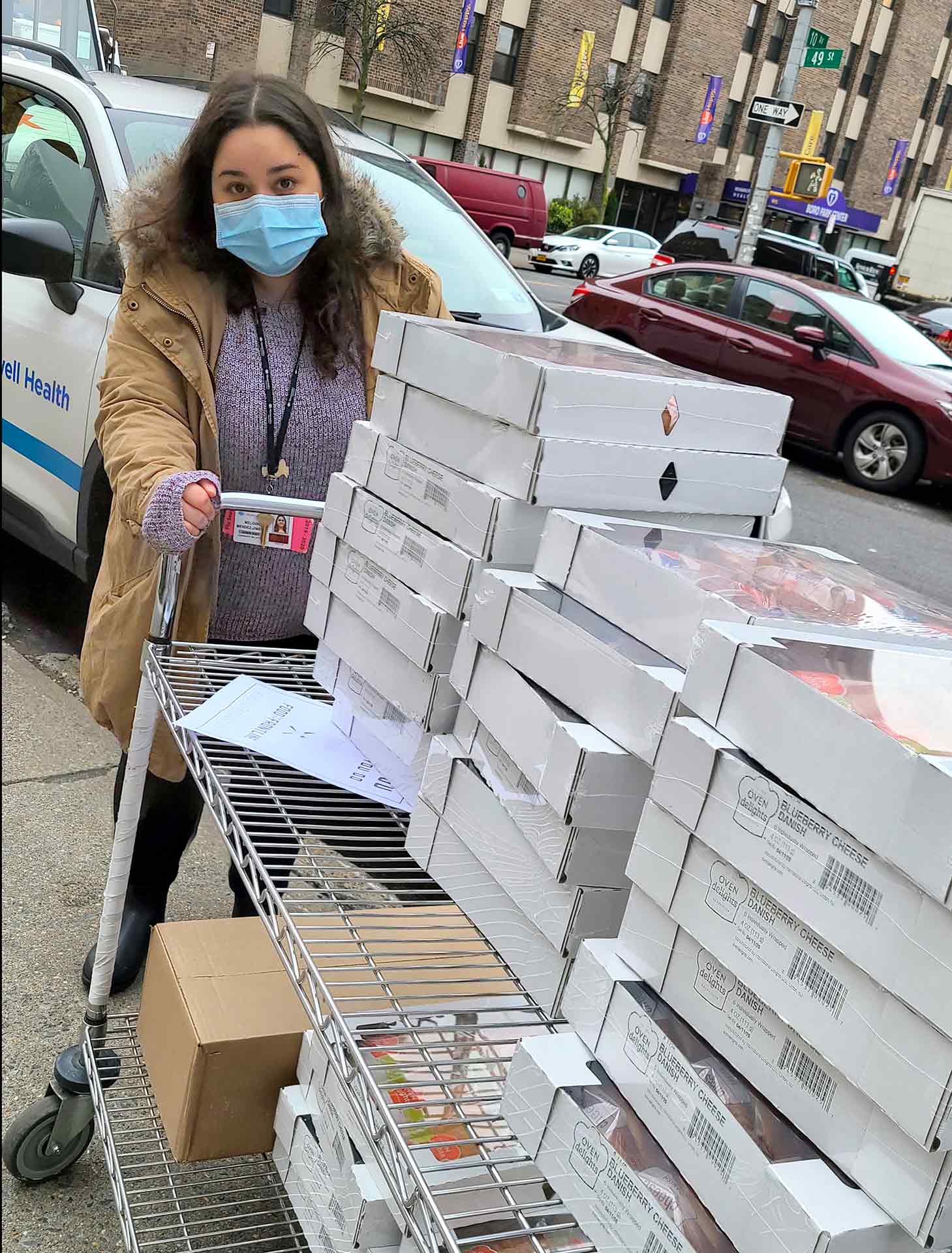 Woman wearing face mask delivers pastries