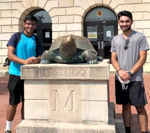 Faris Ali and Ayman Bootwala pose with Testudo statue