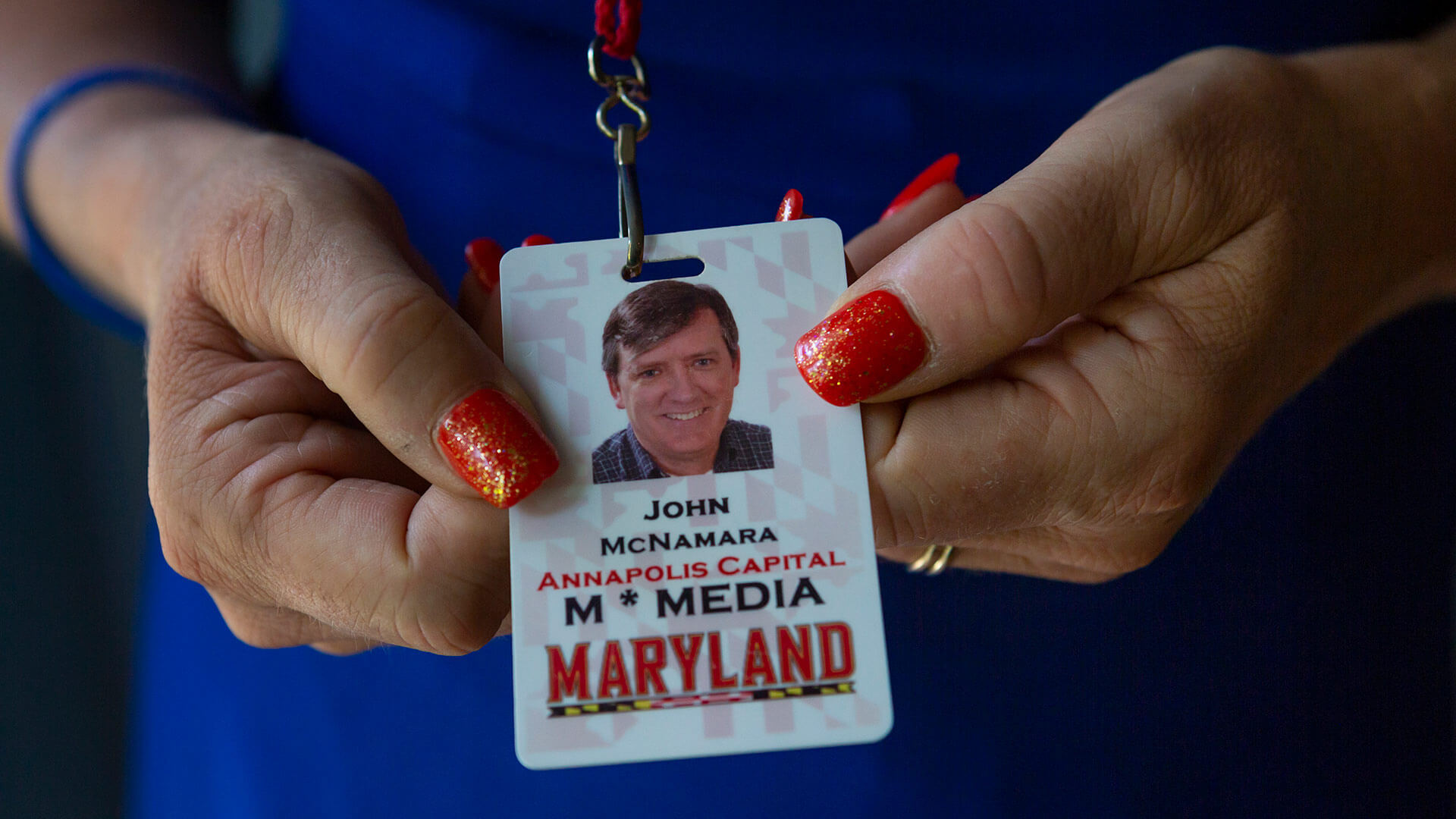 Andrea Chamblee holds John McNamara's Annapolis Capital press pass