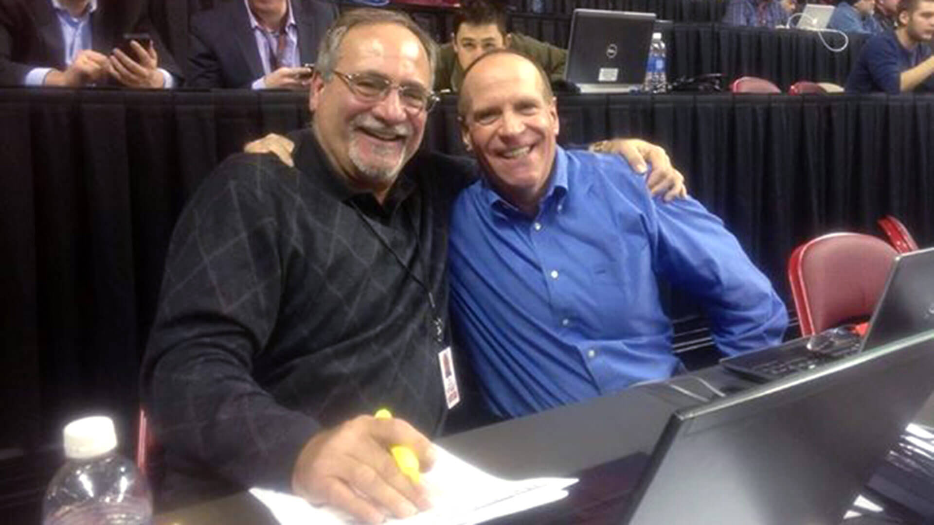 Dave Ginsburg sits with his brother, Steve, on press row at the Xfinity Center