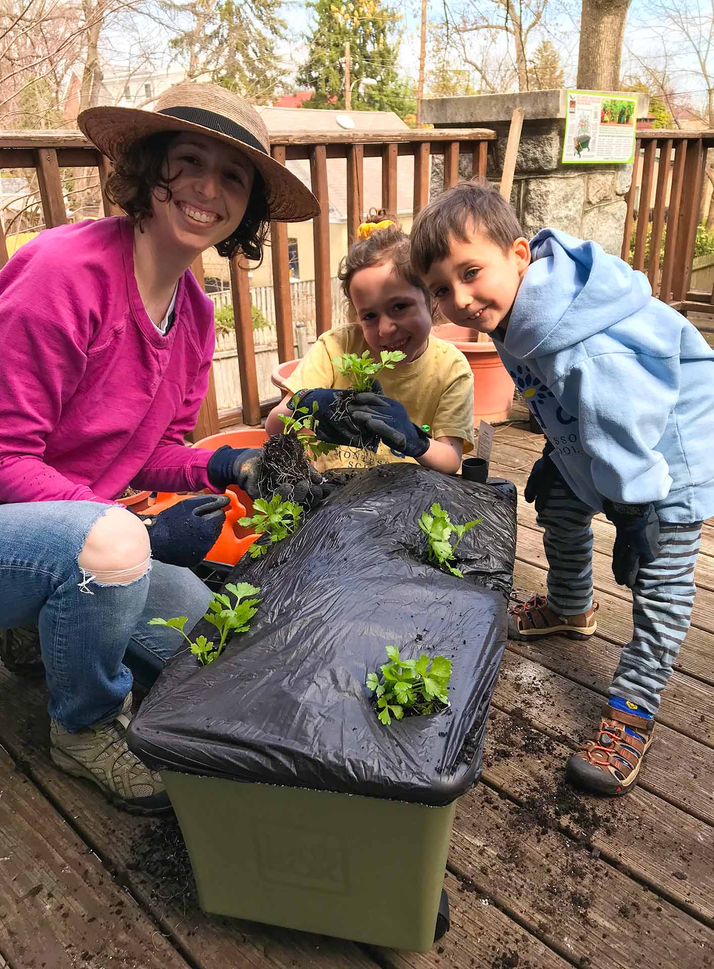 Rachel Rosenberg Goldstein plants a container garden on her deck with her kids