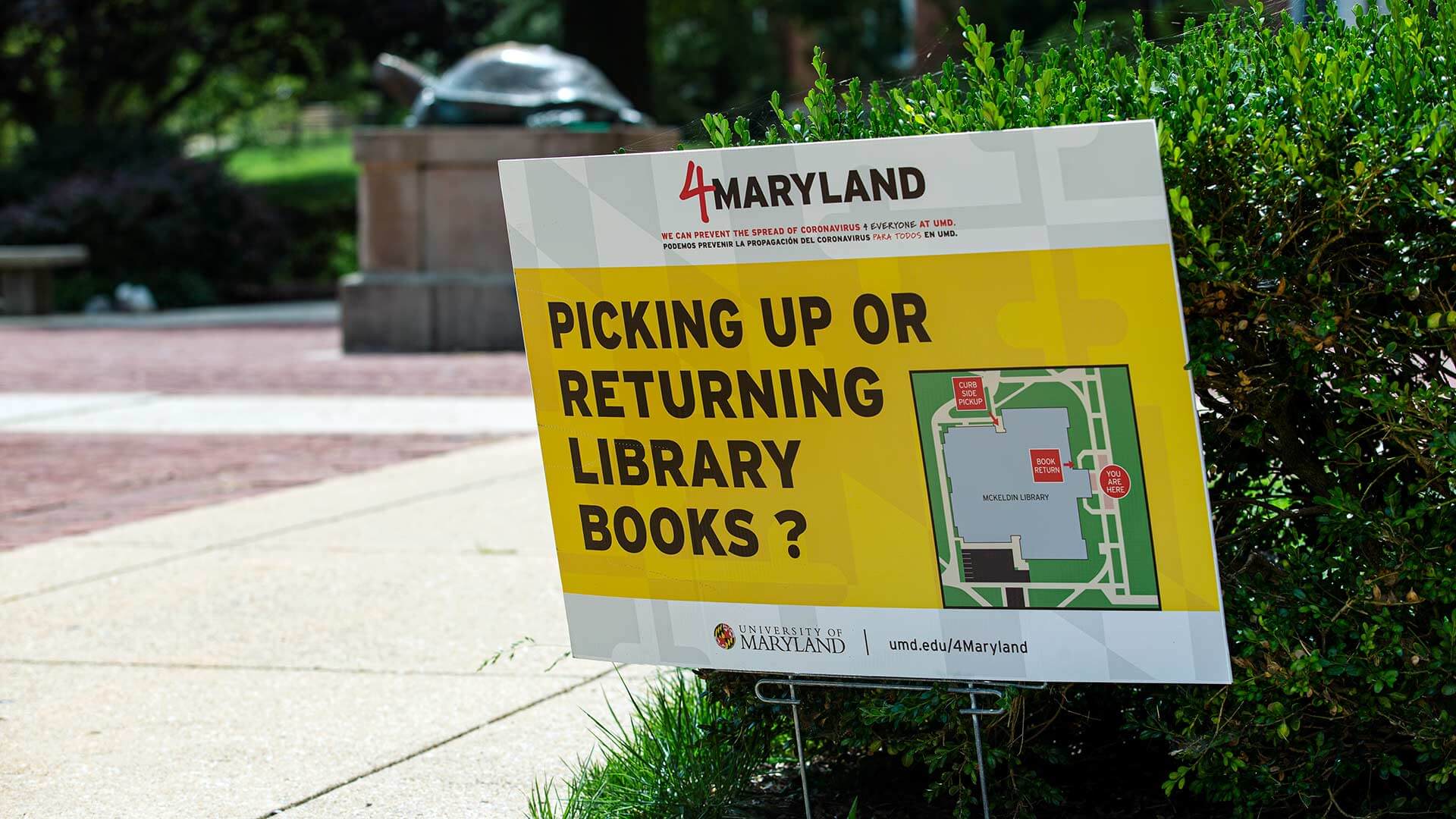 Lawn sign that reads, "Picking up or returning library books?"