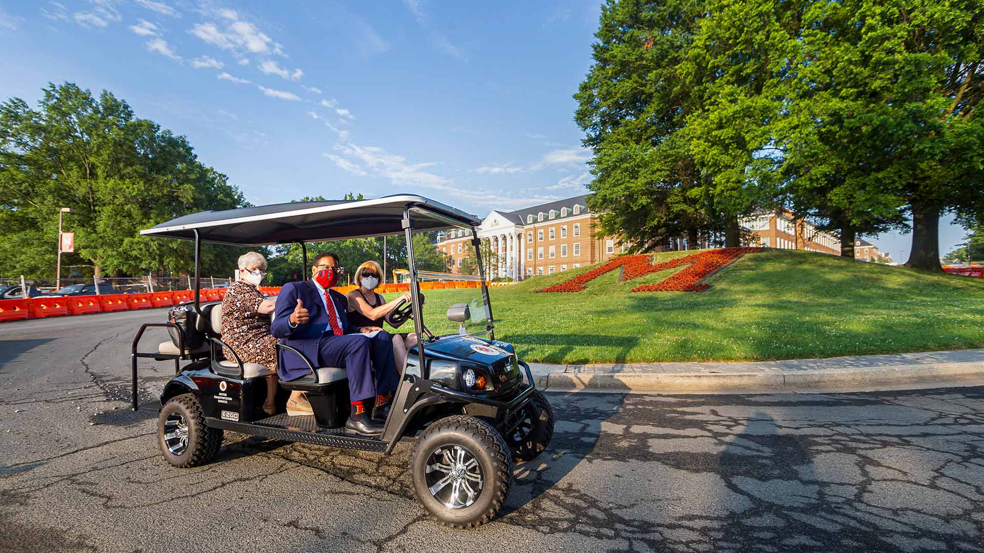 Darryll Pines rides golf cart past M