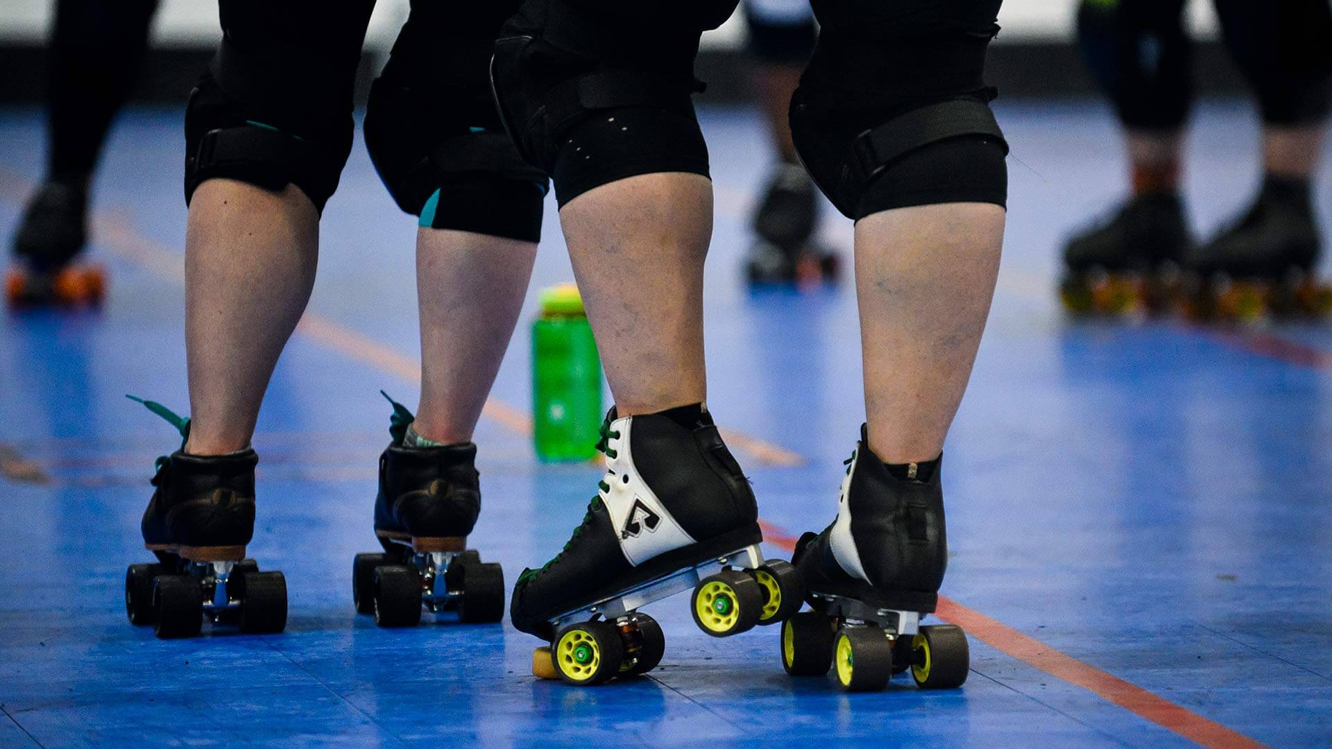 Closeup of roller skates at a roller derby practice
