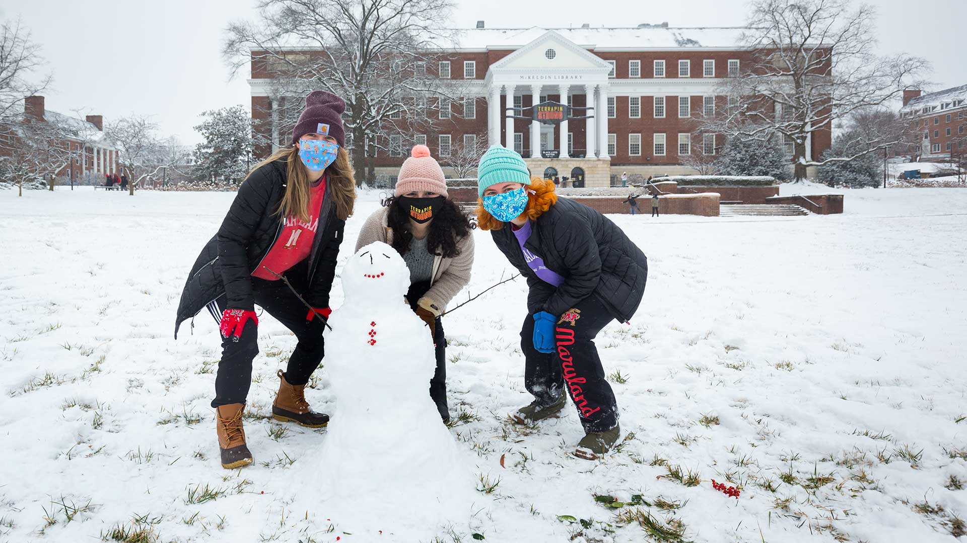 Students build small snowman on McKeldin Mall