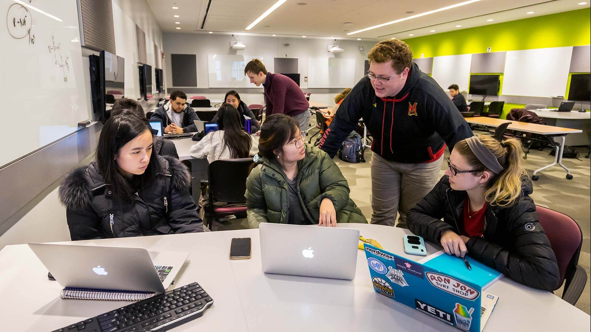 Students sit at tables around screens in Media Share TERP Classrooms