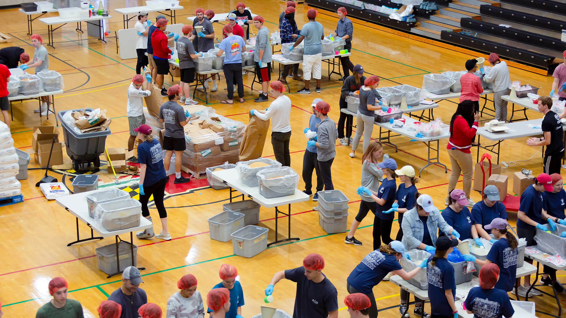 Students volunteer packing meals
