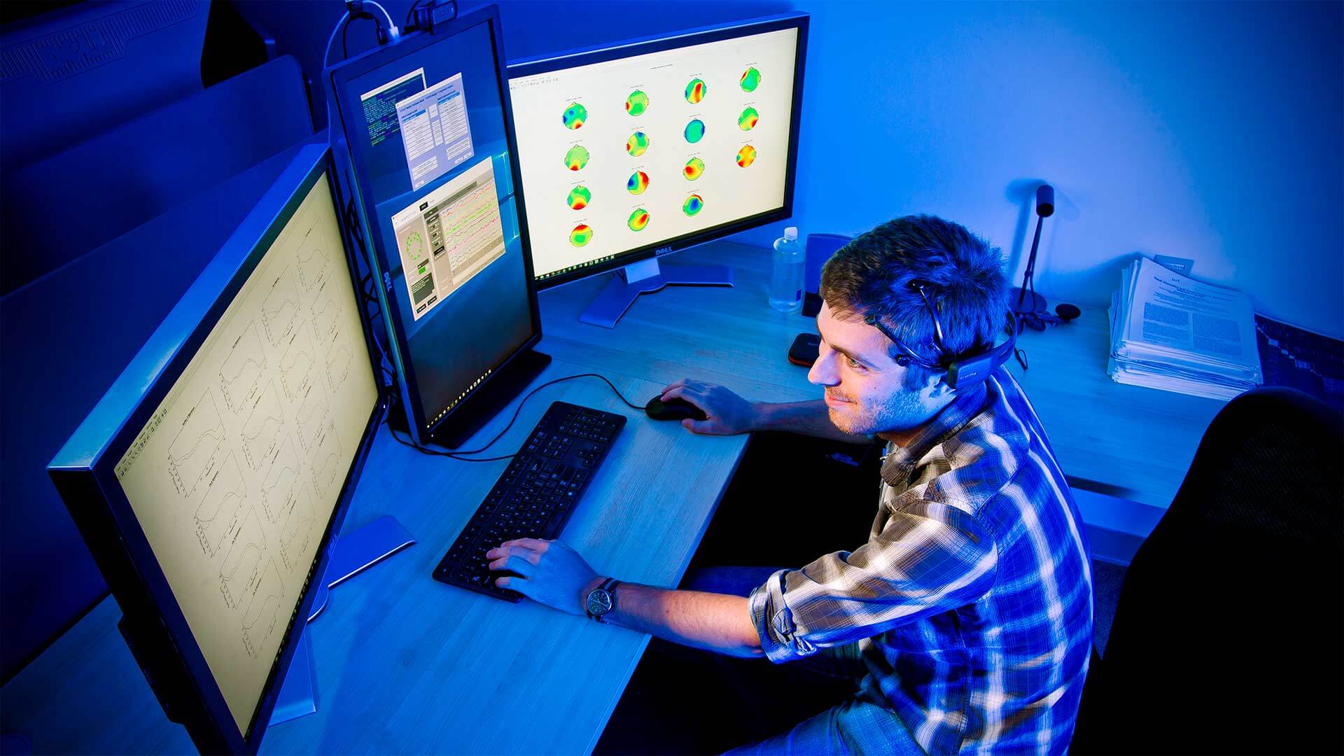 Researcher looks at brain images on computer