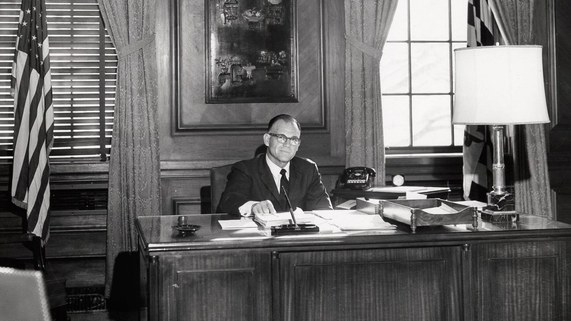 Wilson Homer “Bull” Elkins sits at desk