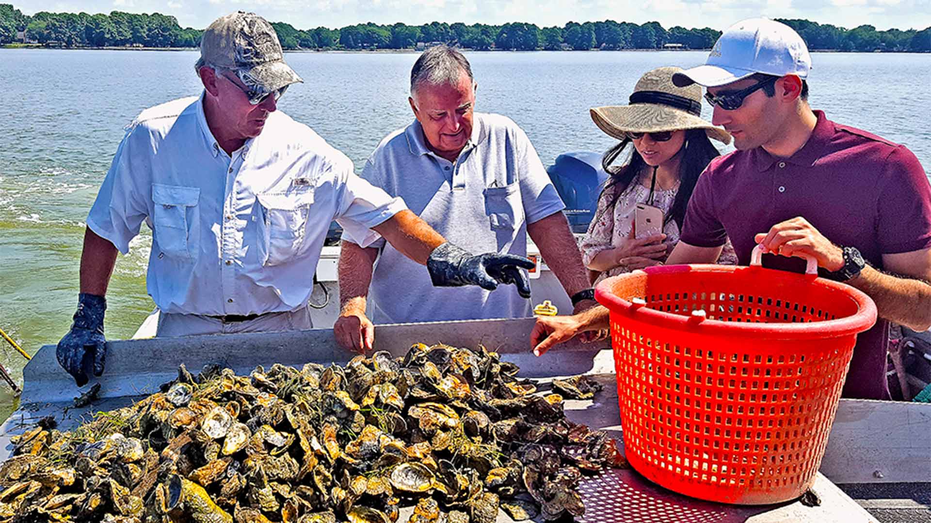 Members of the research team working together in the Chesapeake Bay for oyster imaging and dredging testing